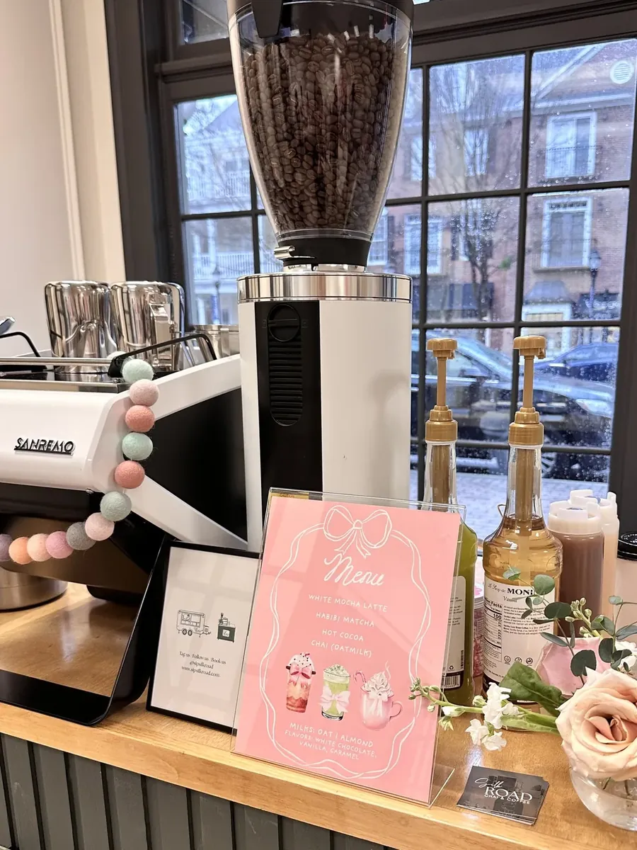 Silk Road espresso setup with syrups, flowers and a seasonal drink menu card
