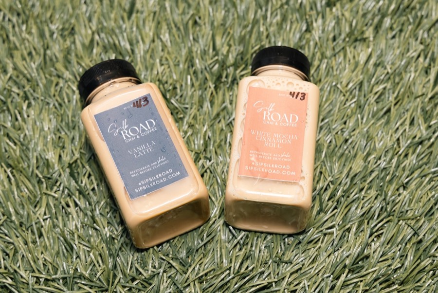 Two Silk Road bottled lattes, coffee and matcha, on the grass