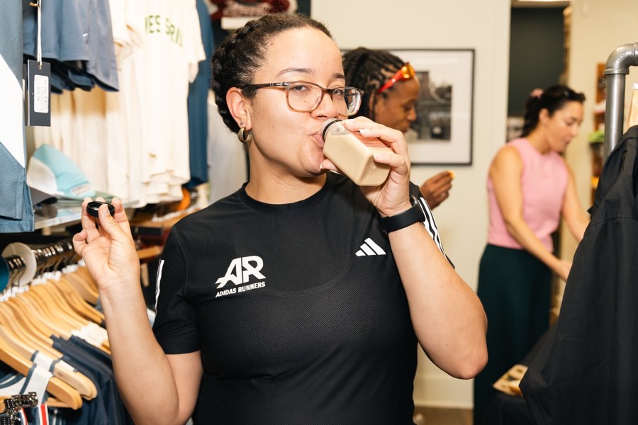 A runner in adidas Runners kit drinking a Silk Road bottled latte