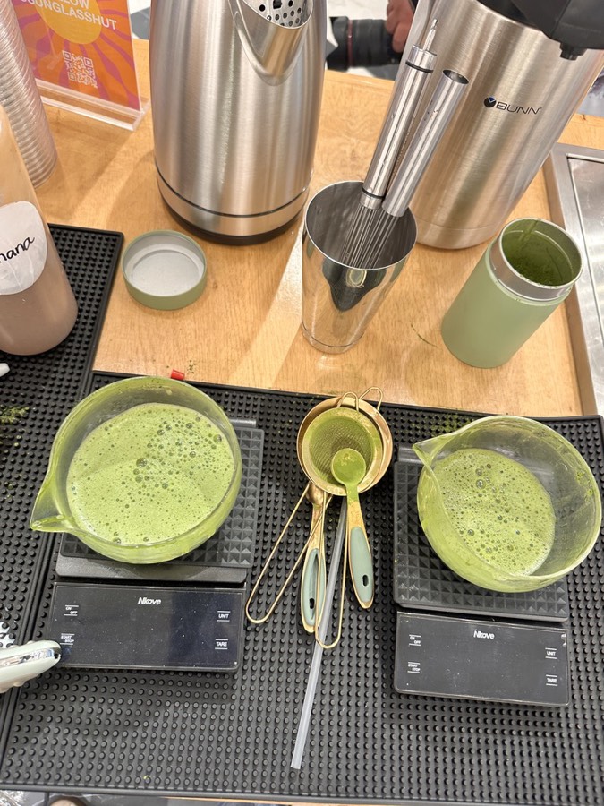 Matcha being whisked and weighed on the bar during the Sunglass Hut event